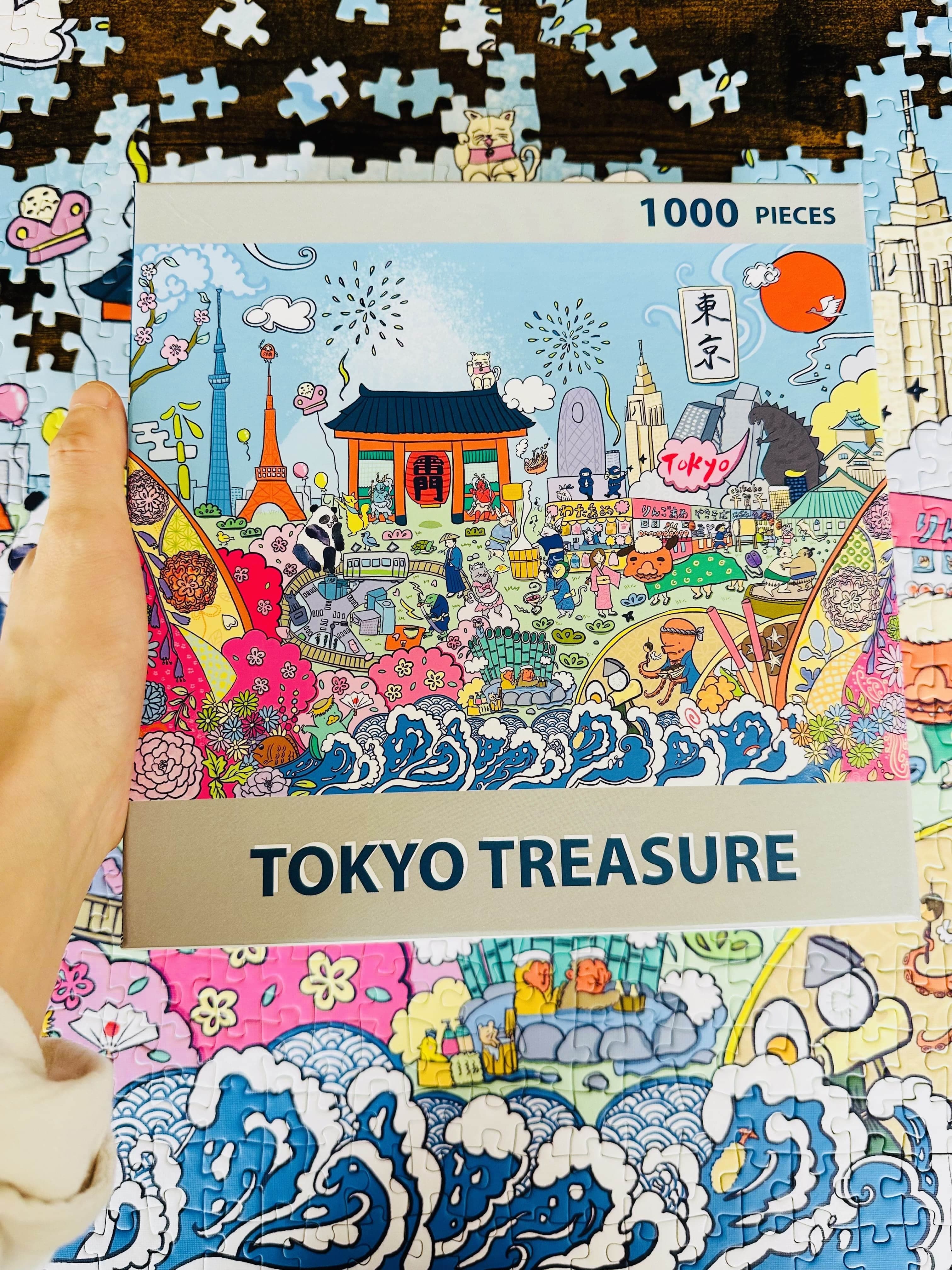 A hand holding the Tokyo Treasure Puzzle box