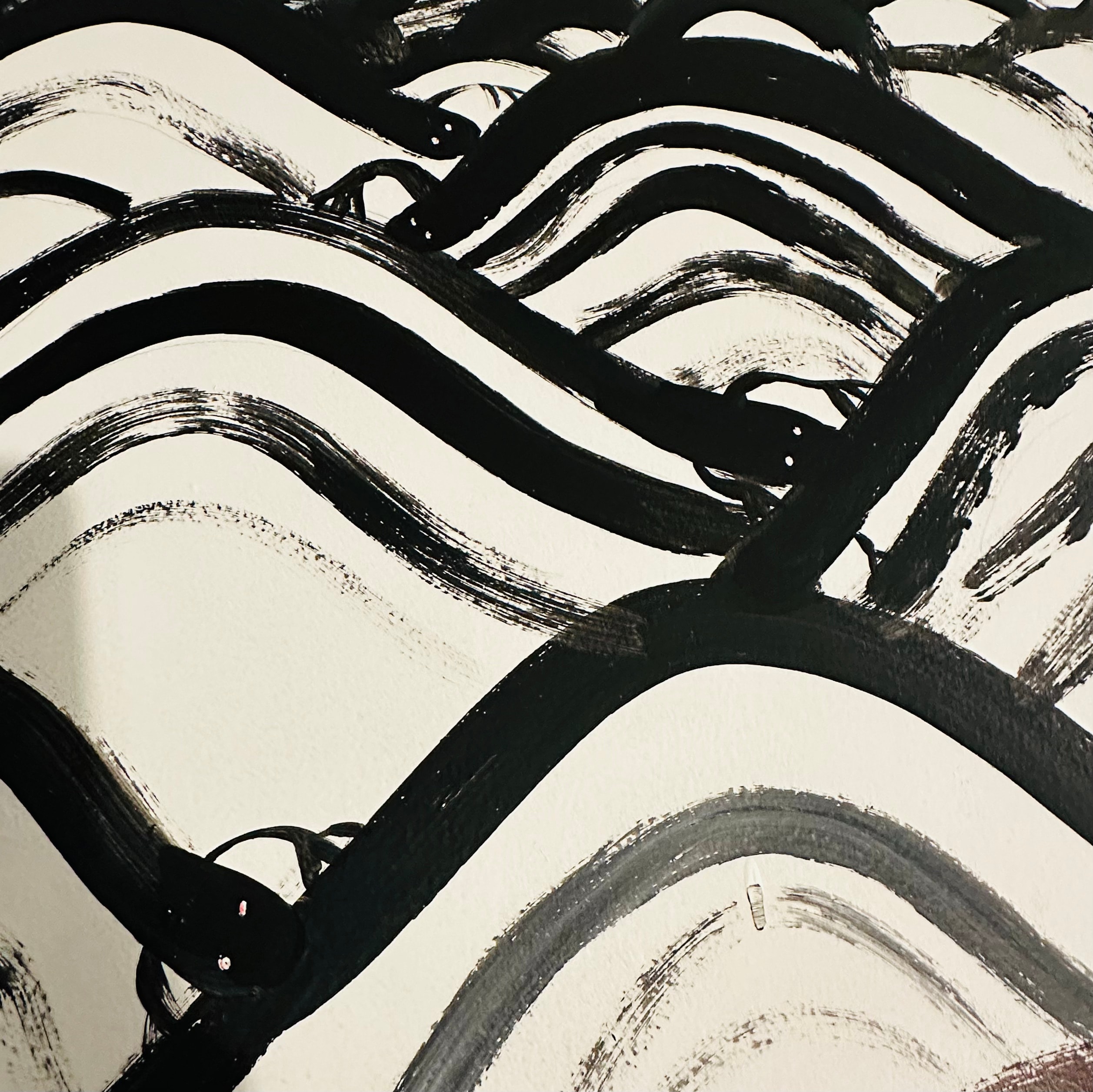 Detail of a black ink brush painting of ocean waves