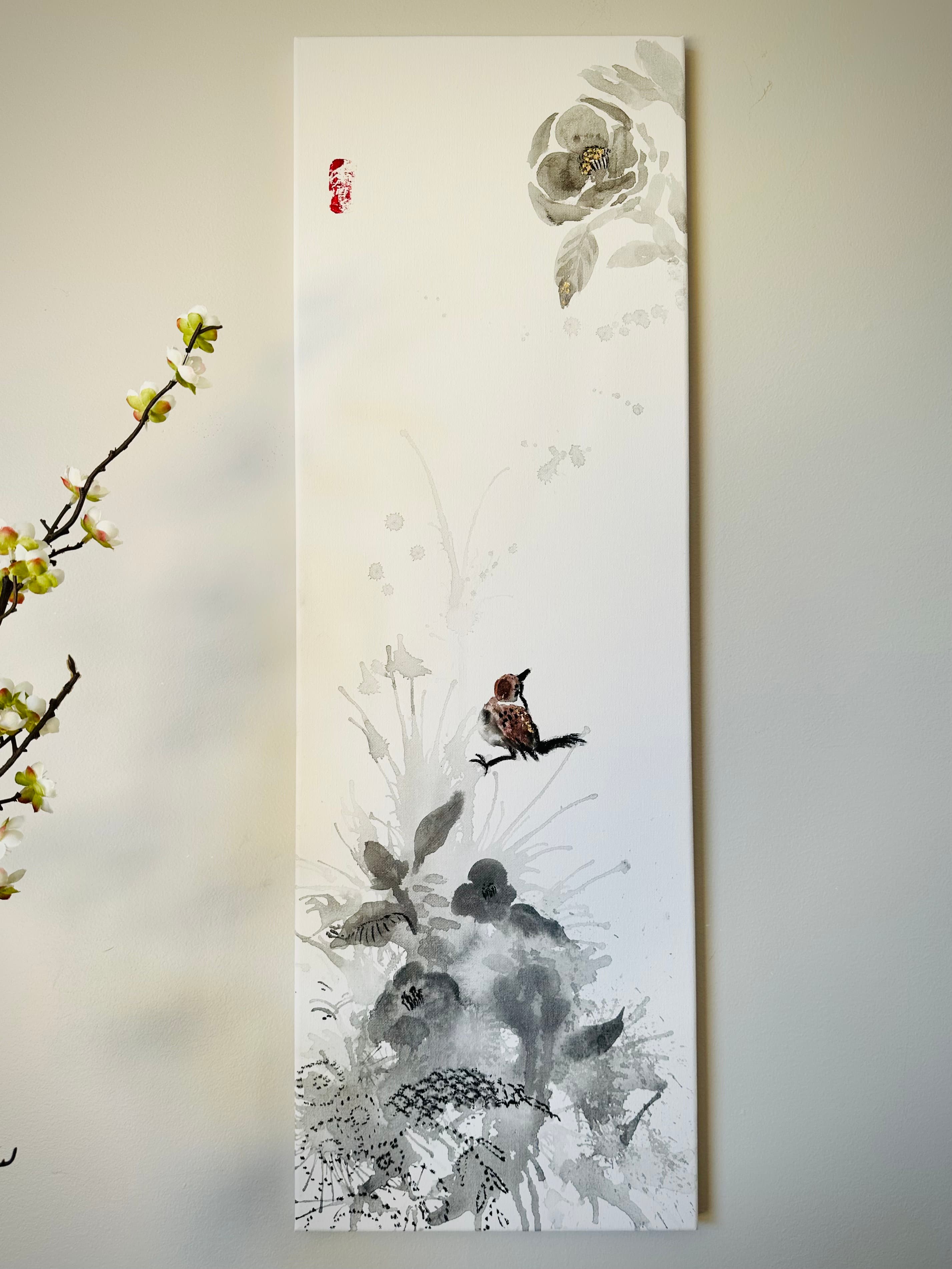 Tall ink painting of a sparrow perched among gray floral branches with a red seal stamp, hung on a wall
